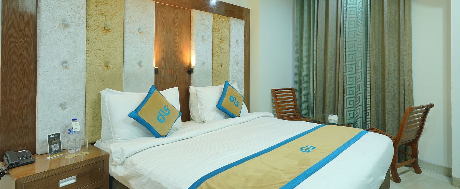 Super deluxe room featuring a king size bed and a window covered with curtains at DLS Hotels The Rock Castle.